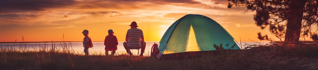Family camping at sunset, symbolizing security and planning with Life Insurance for children