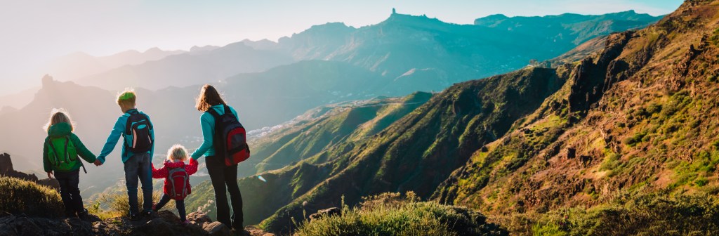 Family hiking together symbolizing security and life insurance for children.