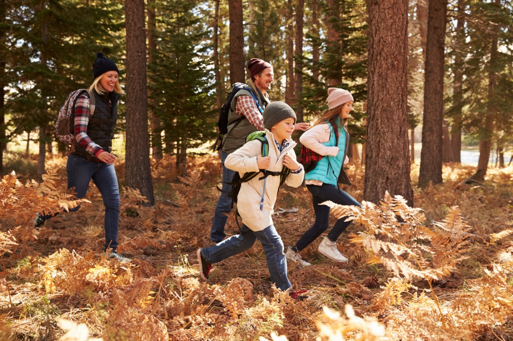 Family hiking together symbolizing security from life insurance for kids.
