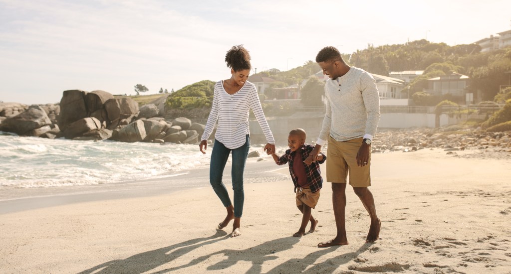 Family walking on the beach symbolizing Generational Wealth and legacy.