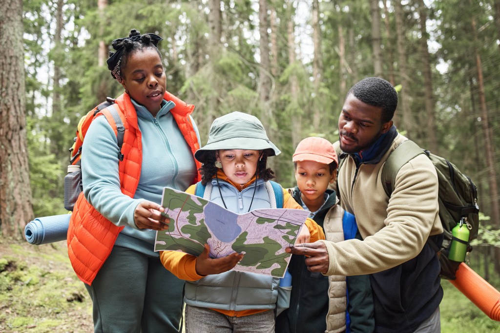 Parents and kids reading a map, representing Generational Wealth planning.