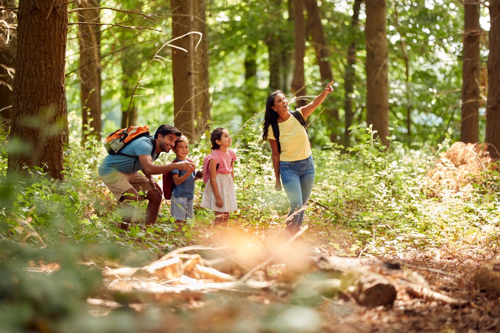 family hiking with children, symbolizing the value of life insurance for kids.