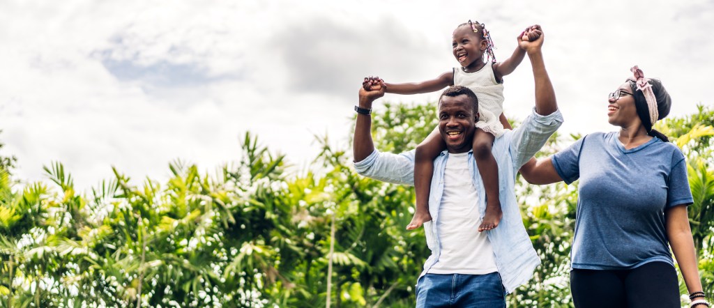 Portrait of enjoy happy love black family african american father and mother with little african girl child smiling and play having fun moments good time in room at home